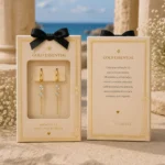Packaging Aros Dorados Colgantes | Gold Essential Aros Dorados Colgantes Glow Secret presentados en su packaging oficial Gold Essential.